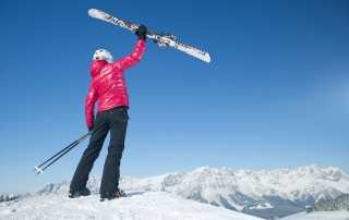 Photo: Woman skiing at the apartment house of your vacation apartment on vacation with dog in Söll Wilder Kaiser Tirol Austria.